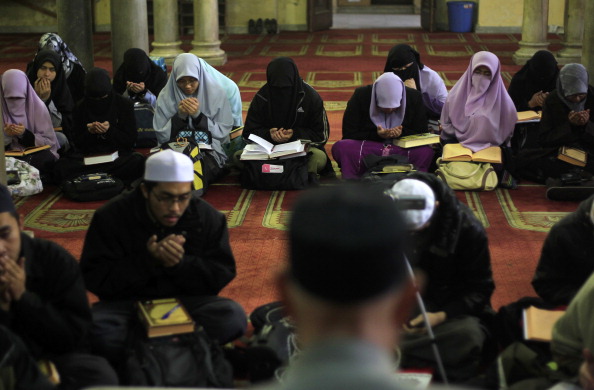 Indonesian Muslim students read from the